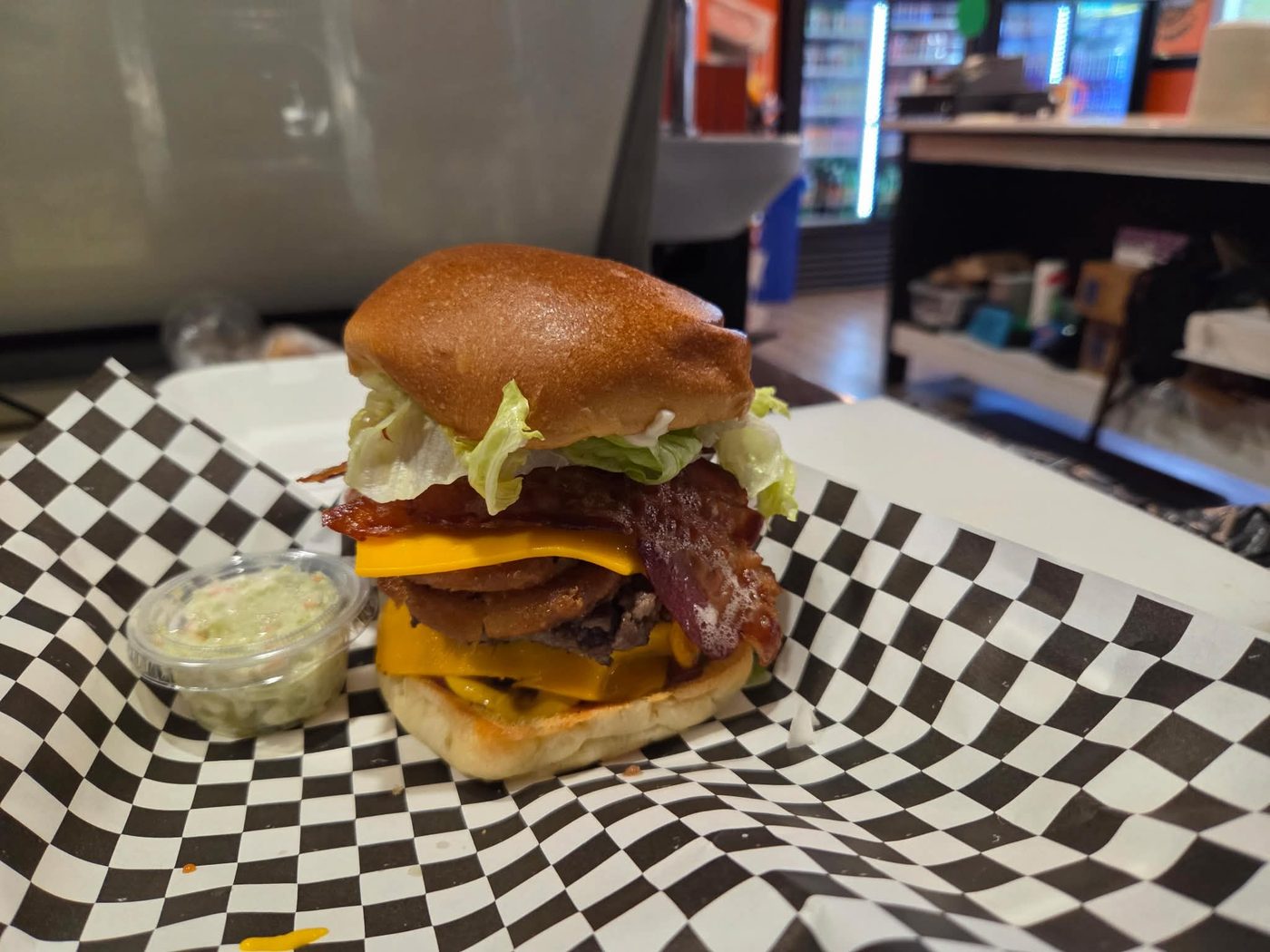 Wayne's Burger stacked with bacon, onion rings and cheddar